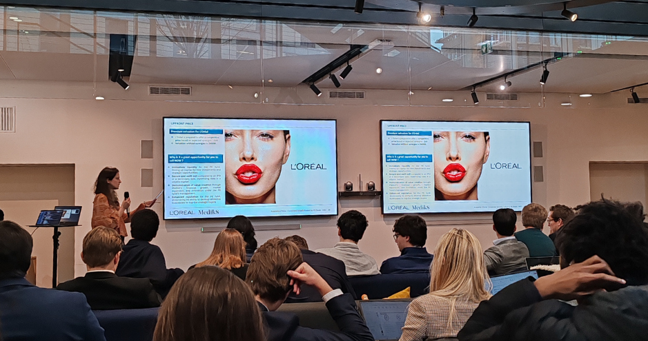 Students attend a presentation on mergers and acquisitions at L'Oréal's headquarters.