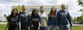 Students walking on campus in MBA hoodies